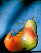 Tomato and pear merged into each other, digital composite