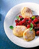 Potato quark buffer with berry compote and icing sugar on plate