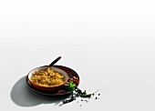 Curry of parrot fish with onions and tomatoes on white background
