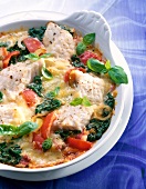 Close-up of spinach casserole with redfish in bowl