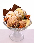 Scoops of ice cream with walnuts, eggnog and chocolate bars in an ice-cream bowl