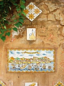 Mediterranean hotel wall with antique hand painted images on wall tiles