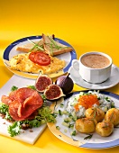 Potatoes with cream cheese, toast with scrambled eggs, bread topped and cappuccino