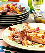 Close-up of tuna, seafood skewers and salmon fillet in dish