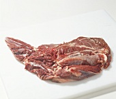 Raw boned shoulder of fallow deer meat on cutting board, step 7