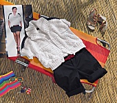 Sun lounger on bamboo mat with short-sleeved cardigan and bermudas