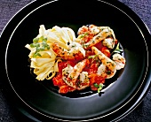 Close-up of tagliatelle with king prawns, herbs and tomato sauce