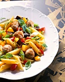 Close-up of penne pasta with meat dumpling and vegetables