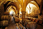 Wine barrels in winery cellar, Arbois, France