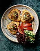 Baked rosti with beefsteak hack, tomatoes and lettuce in dish