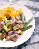 Close-up of liver stew with shallots and noodles on plate