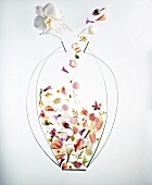 Cut out of flower vase with different type of flower petals falling into it