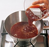 Jelly and jam being added in pan, step 3