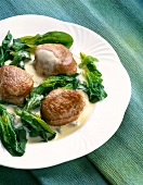 Pork medallions with gorgonzola sauce on plate