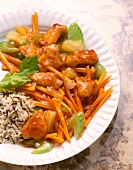 Close-up of sweet and sour chicken with rice and vegetables on plate