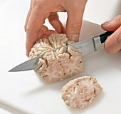 Boiled deer brain being cut into slices, step 4