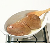 Deer liver being boiled in baking dish, step 2