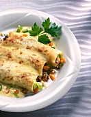 Close-up of stuffed cannelloni with parsley on plate