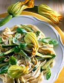 Close-up of tagliatelle with zucchini, basil and parmesan cheese on plate