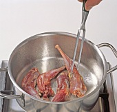 Leg stew being fried in pot, step 1
