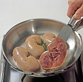 Close-up of wild boar kidneys being fried in pan, step 3
