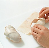 Close-up of wild boar kidney being wrapped in dough, step 5