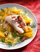 Close-up of redfish fillet with vegetables on plate