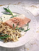 Close-up of salmon trout fillet with champagne sauce and rice on plate