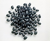 Close-up of black soybeans on white background