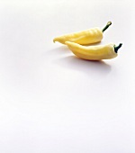Close-up of two yellow paprika on white background