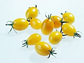 Yellow cherry tomatoes on white background