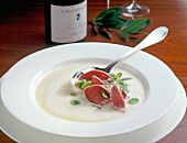 Close-up of cream soup with smoked beef tongue on plate