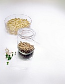 Mung beans in bowl, chickpeas in jar and radish seeds on white background