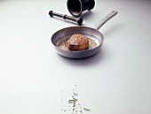 Beef steak in pan with mortar and pestle on white background, copy space
