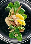 Asparagus and goose meat salad on glass plate, overhead view