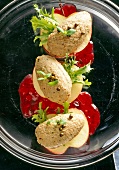 Close-up of goose mousse with green pepper, apple slices and cranberry in plate