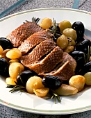 Goose Breast in the Italian way with shallots and black olives on serving dish