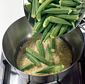 Adding okra to onions and butter in saucepan, step 1