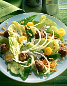 Close-up of lentil salad with meatballs and sweet peas on plate