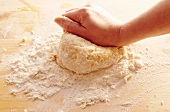 Close-up of person kneading dough for preparing pasta, step 4