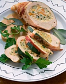 Sliced chicken breast stuffed with cheese on plate
