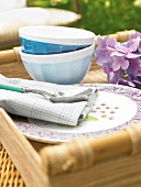 Close-up of bamboo tray with dishes, spoon and bowl