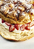 Close-up of strawberry cake with cream puffs