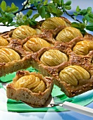 Close-up of toffee apple cake and one piece on spatula