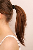Close-up of Magdalena woman's brown hair tied up in ponytail
