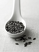 Black glutinous rice in white spoon, black and white