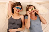 Magdalena and Charlotte women lying wearing eye masks, laughing