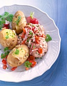 Boiled potatoes with dip of tomato, radish and curd on dish