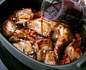 Rabbit's meat being marinated with herbs