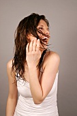 Ecstatic Magdalena woman with wet brown hair looking sideways, laughing